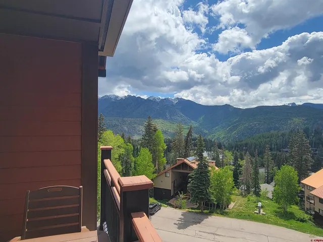 a view of a balcony with chair and table