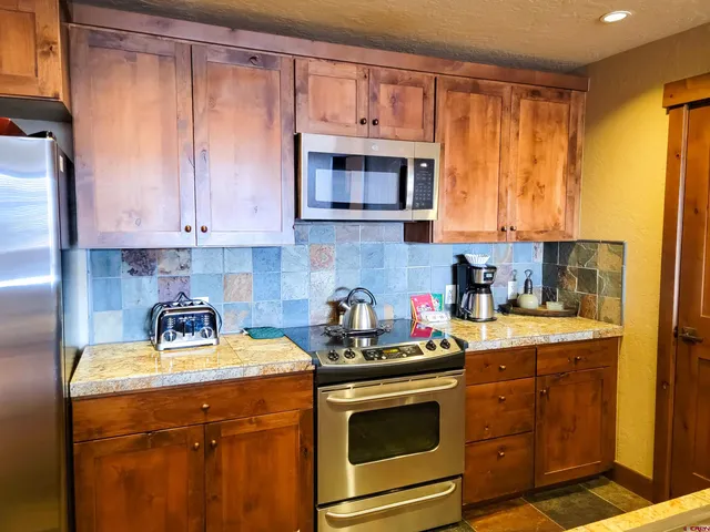 a kitchen with a sink stove and microwave