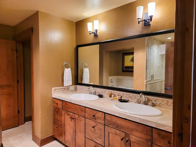 a bathroom with a double vanity sink and a mirror