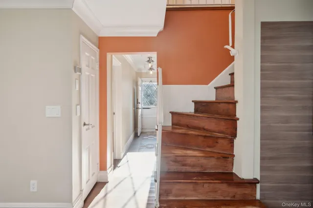 a view of entryway and hall with wooden floor