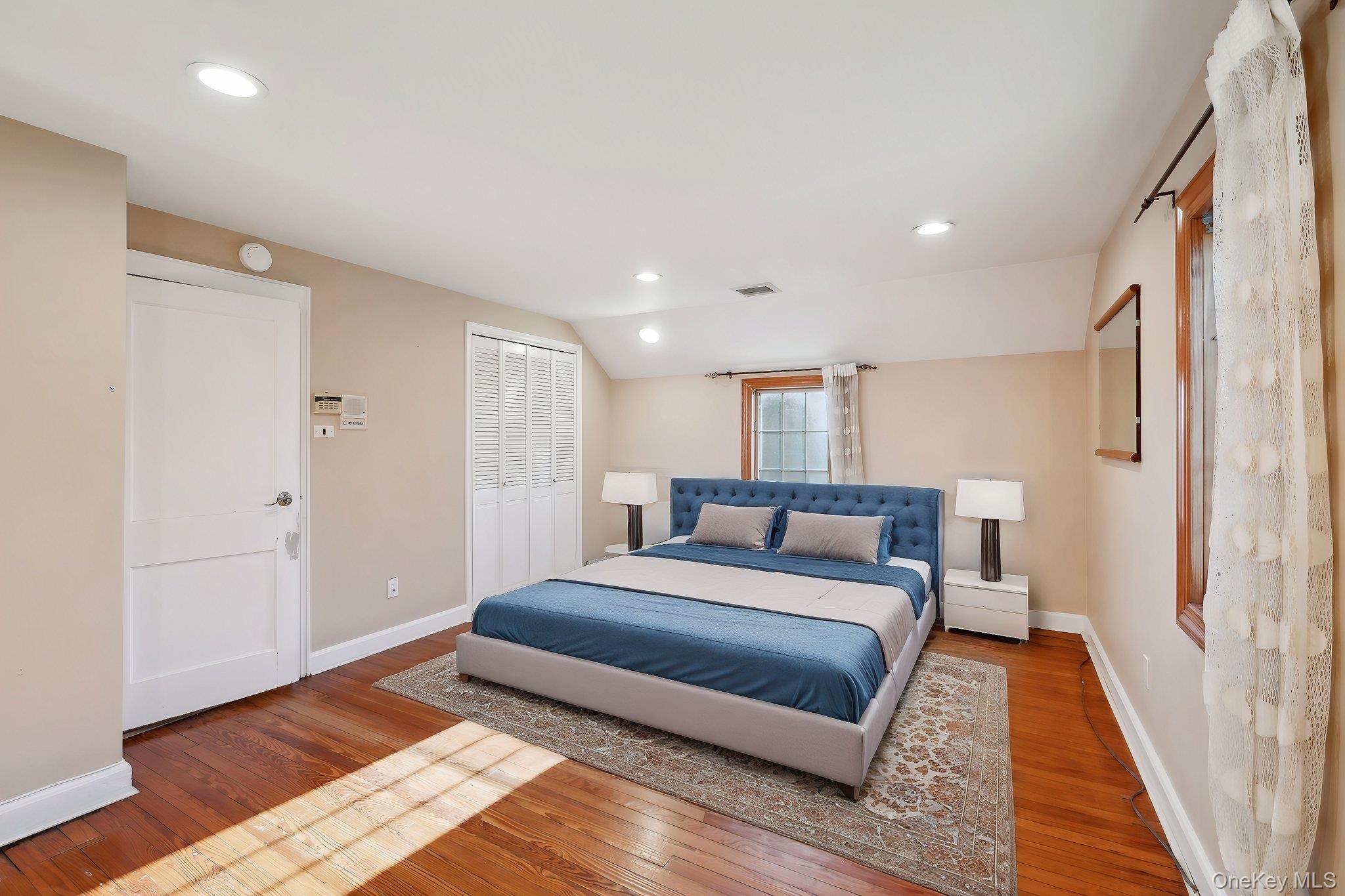 1250 Harbor Road Hewlett, NY 11557 - Photo 12 of 18 a spacious bedroom with a bed and a rug