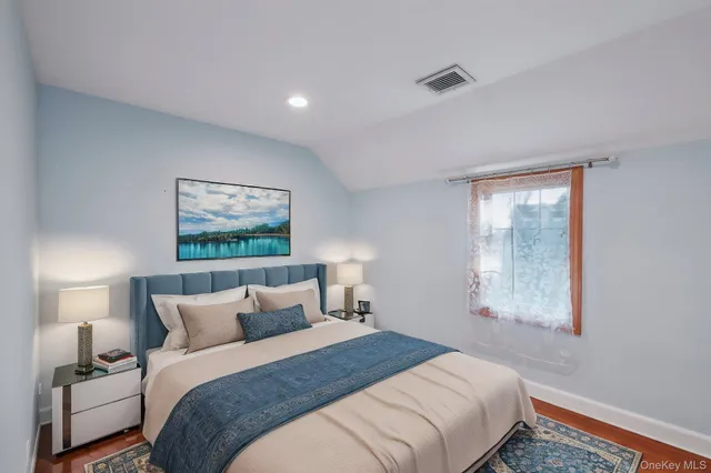 a bedroom with bed and window