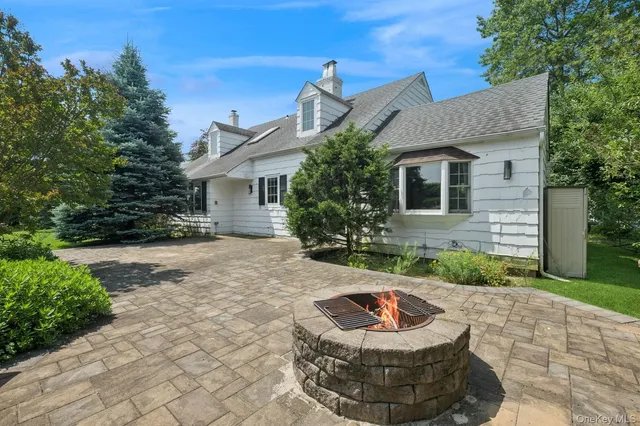 a front view of house with yard outdoor seating and green space