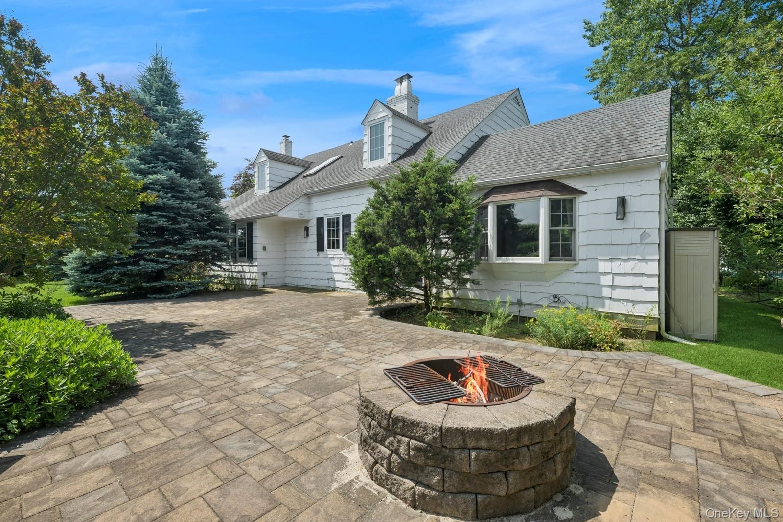 1250 Harbor Road Hewlett, NY 11557 - Photo 18 of 18 a front view of house with yard outdoor seating and green space