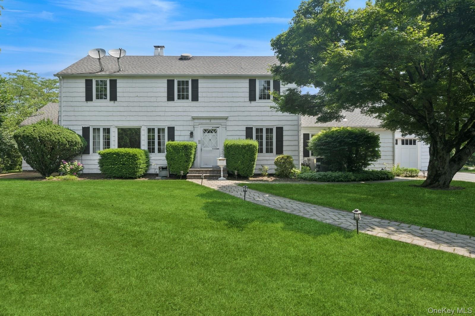 1250 Harbor Road Hewlett, NY 11557 - Photo 2 of 18 a front view of a house with a yard and trees