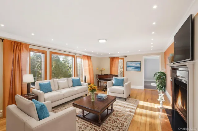 a living room with fireplace furniture and a flat screen tv