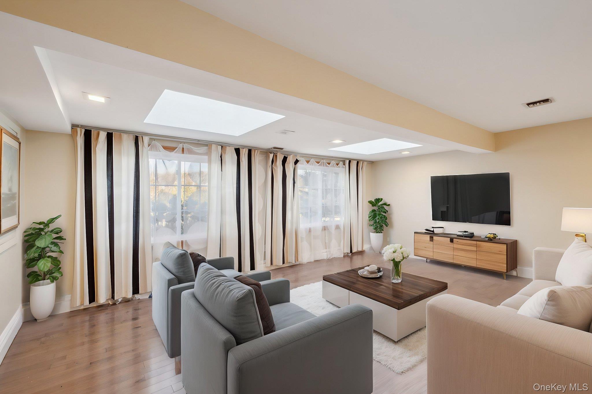 1250 Harbor Road Hewlett, NY 11557 - Photo 5 of 18 a living room with furniture and a flat screen tv