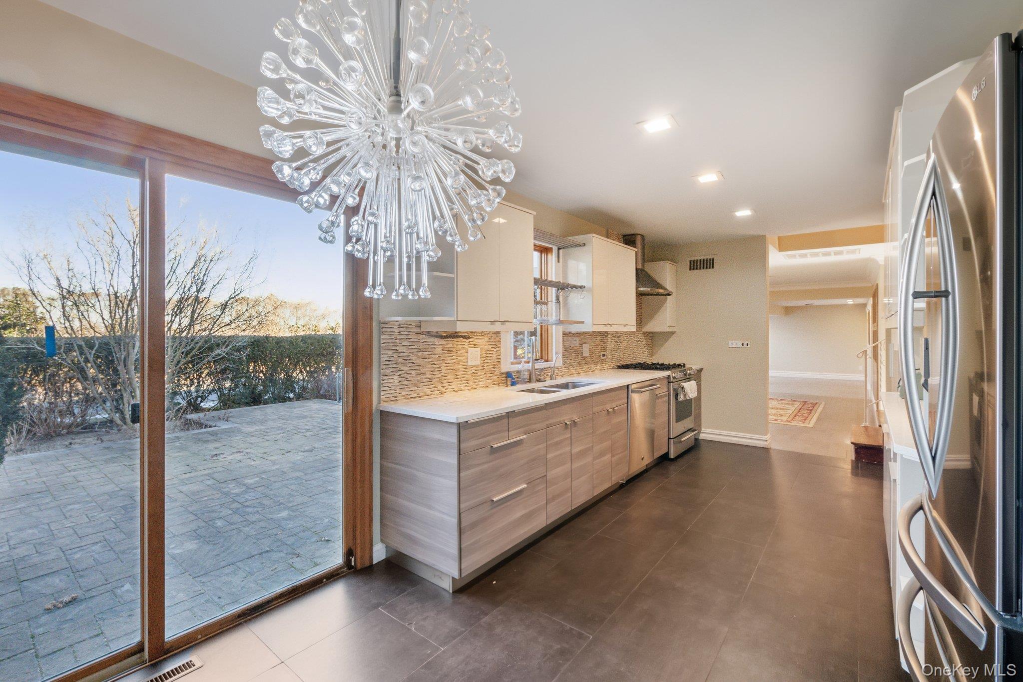 1250 Harbor Road Hewlett, NY 11557 - Photo 7 of 18 a kitchen with stainless steel appliances granite countertop a refrigerator a sink and a stove