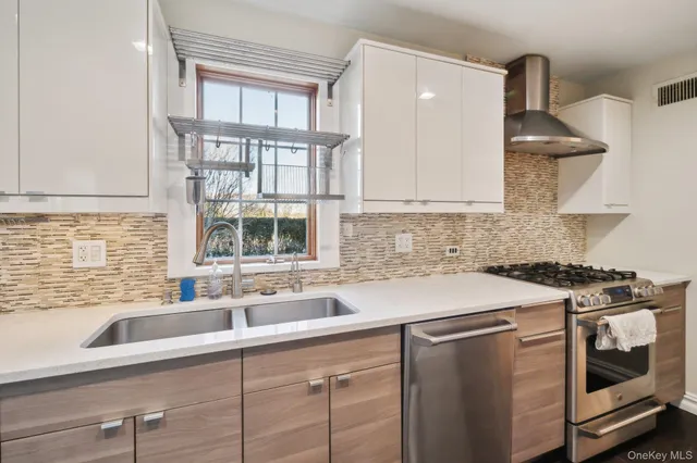 a kitchen with stainless steel appliances a sink stove and cabinets