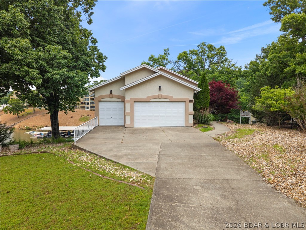 2247 Breezy Acres Road Osage Beach, MO 65065 - Photo 7 of 53 FLAT driveway and 3 car garage provides plenty of