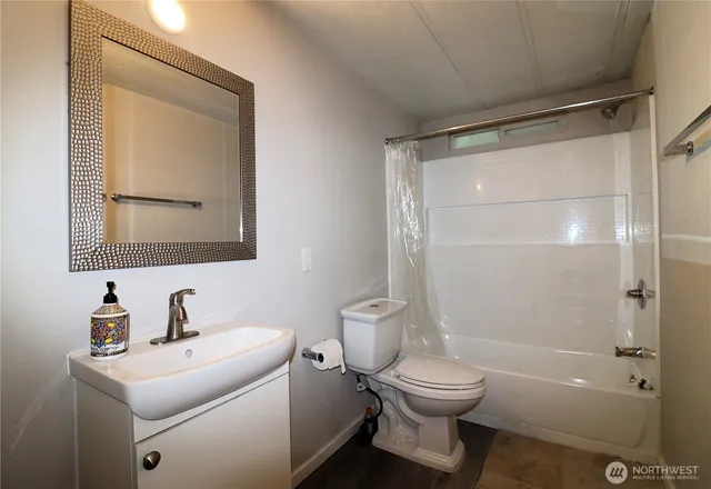 a bathroom with a toilet a sink and a mirror