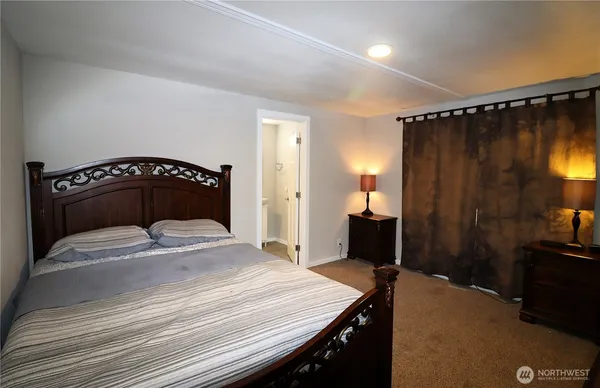 a bedroom with a bed and a bathroom