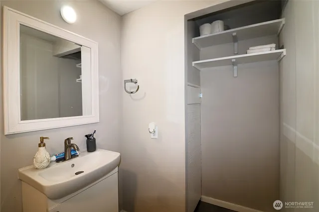 a bathroom with a sink a toilet and a mirror