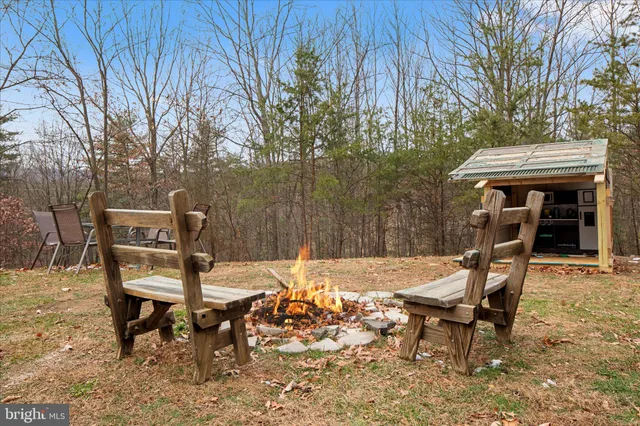 a view of a chairs and table in backyard of the house
