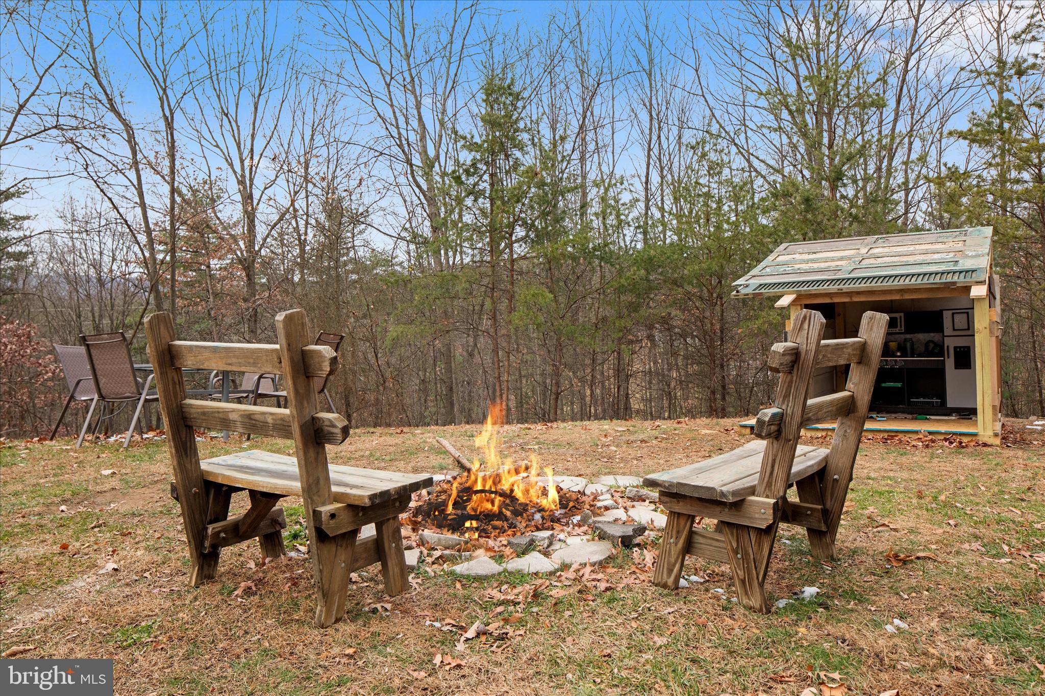 985 Waugh Road Berkeley Springs, WV 25411 - Photo 1 of 22 a view of a chairs and table in backyard of the house