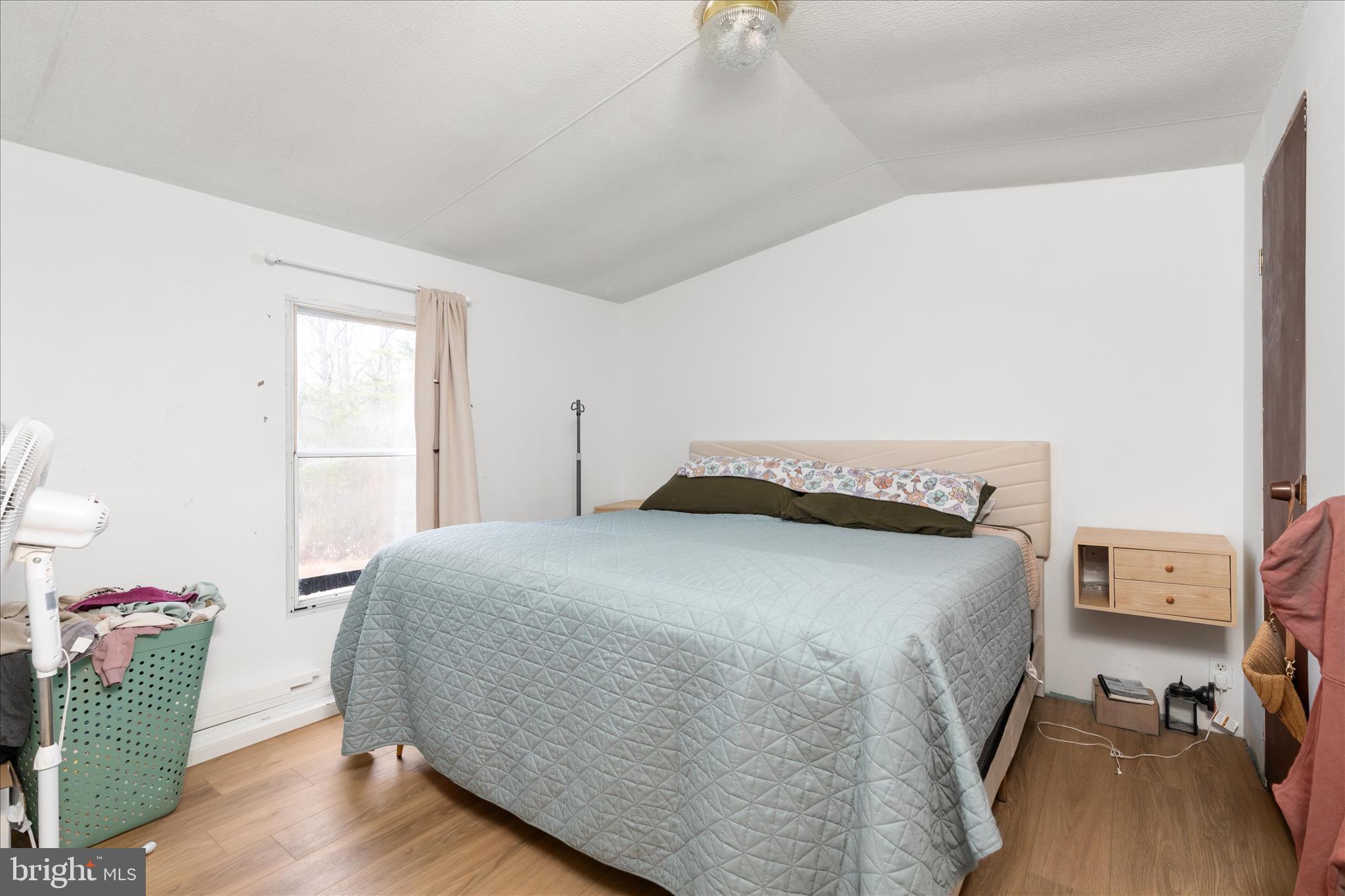 985 Waugh Road Berkeley Springs, WV 25411 - Photo 11 of 22 a bedroom with a bed and wooden floor