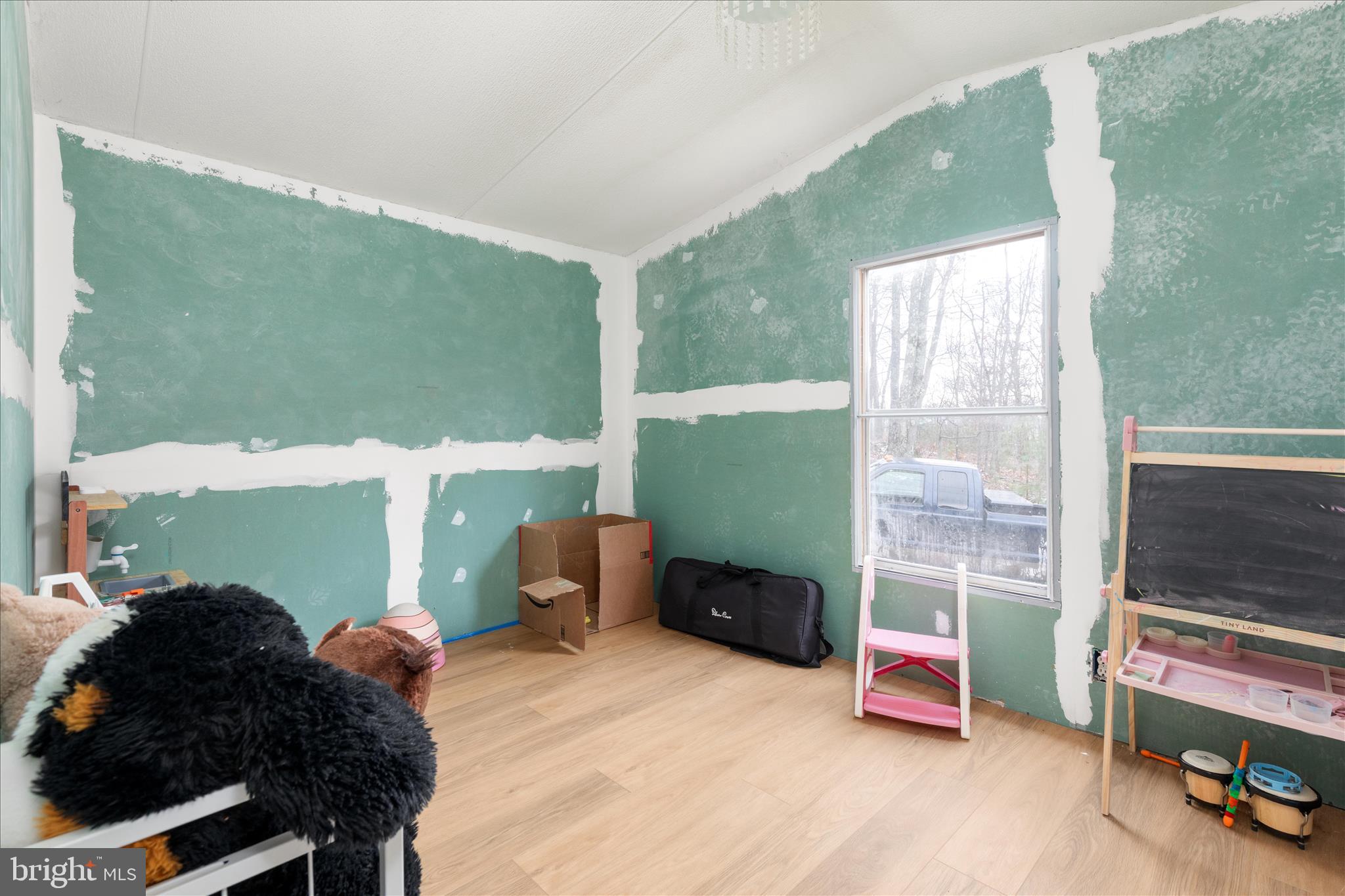 985 Waugh Road Berkeley Springs, WV 25411 - Photo 14 of 22 a living room with furniture and a floor to ceiling window
