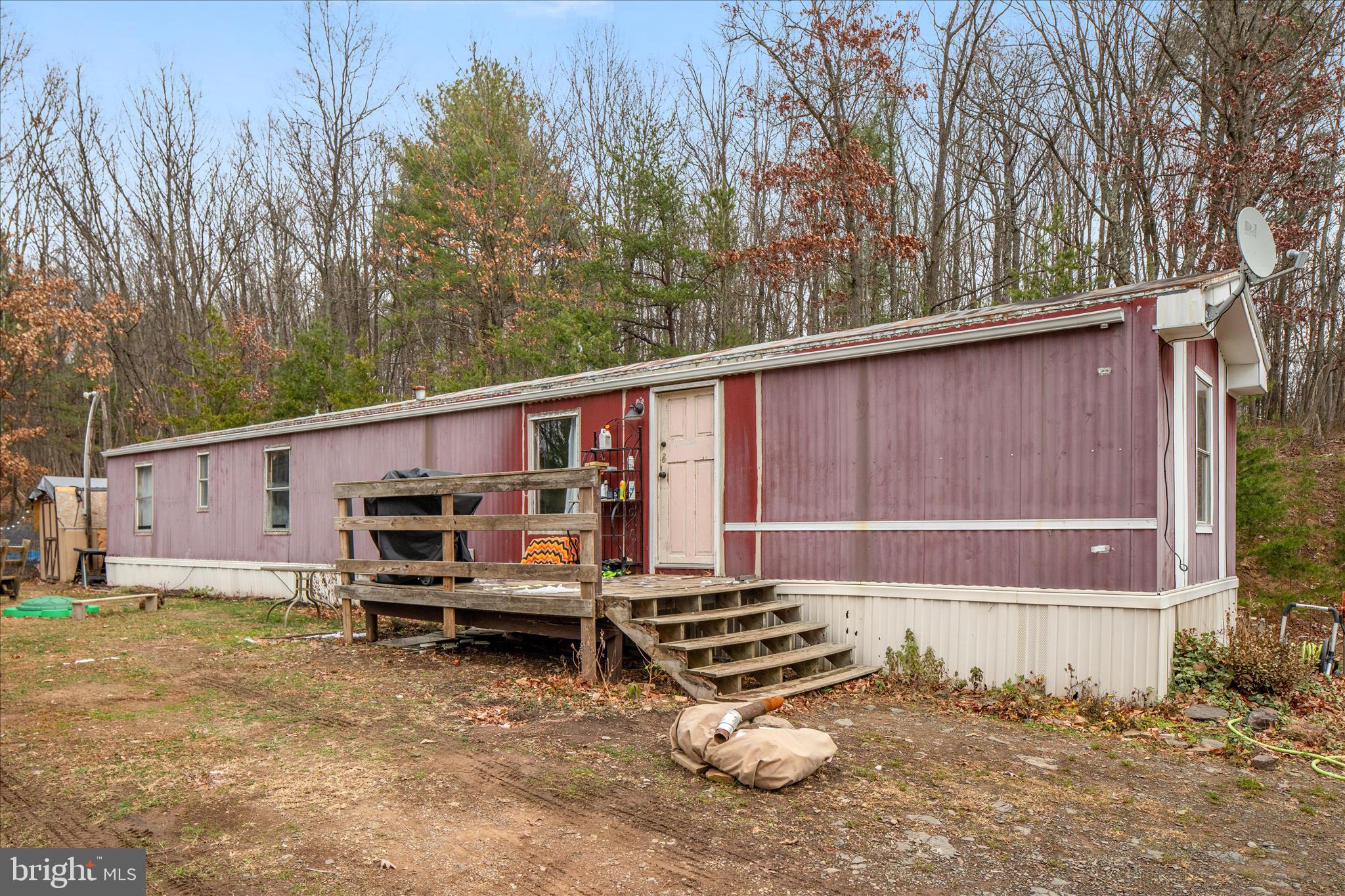 985 Waugh Road Berkeley Springs, WV 25411 - Photo 3 of 22 a view of a backyard with chairs and a fence
