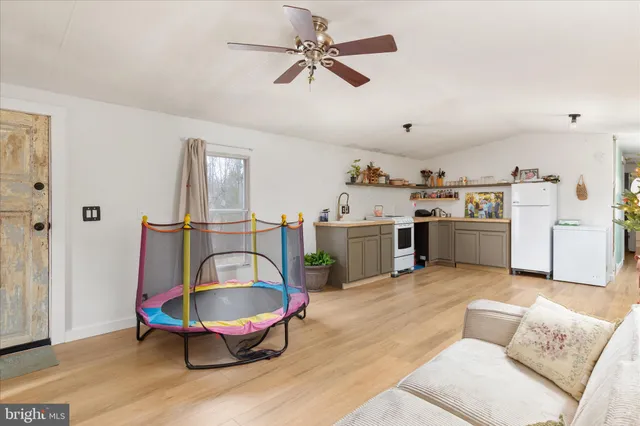 a living room with furniture a chandelier and a rug