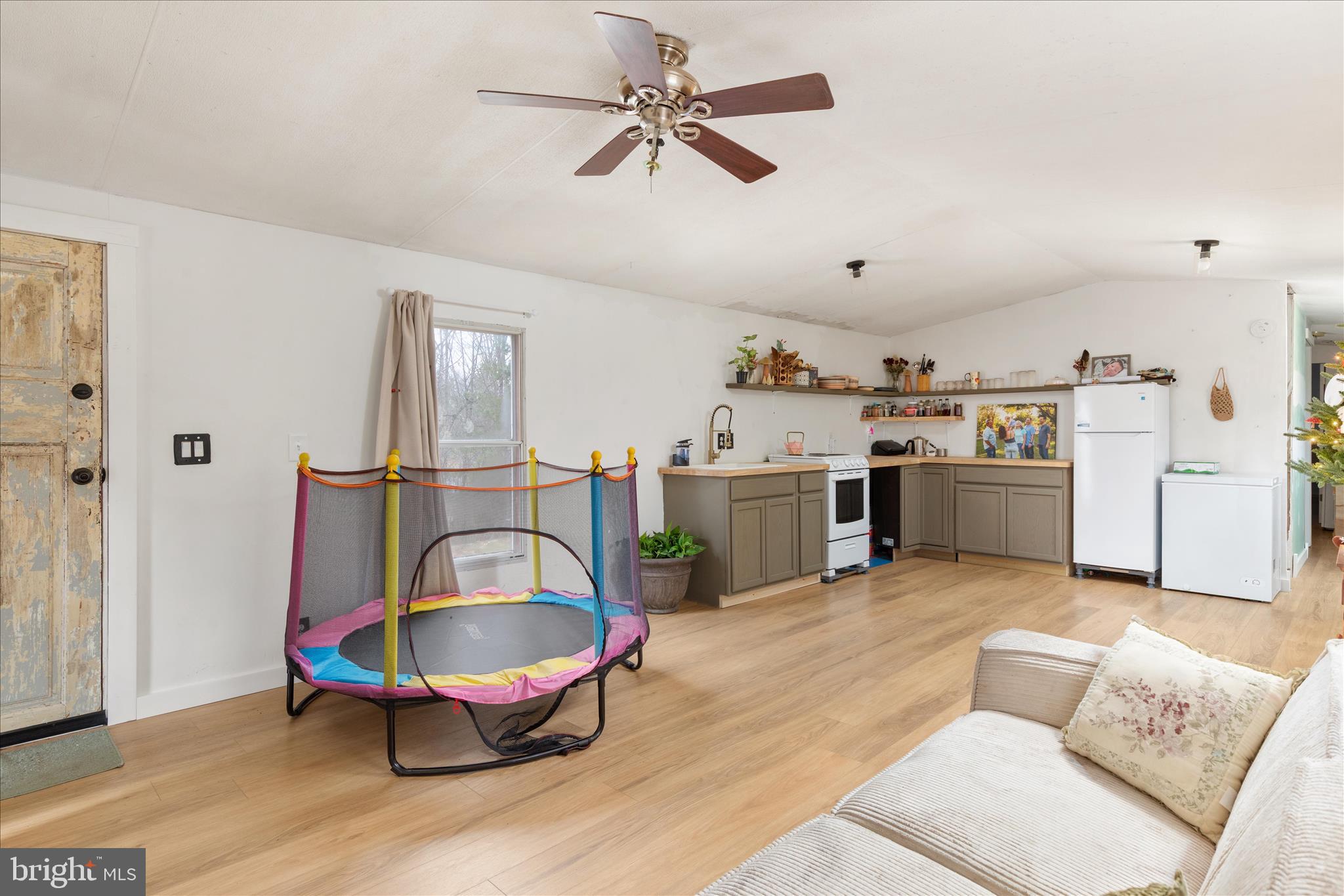985 Waugh Road Berkeley Springs, WV 25411 - Photo 4 of 22 a living room with furniture a chandelier and a rug