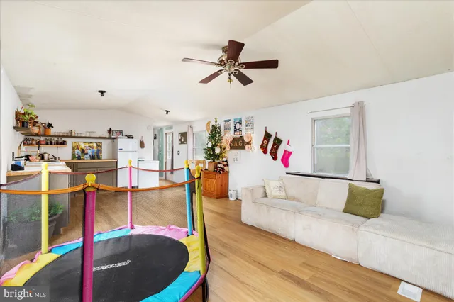 a living room with furniture and kitchen view