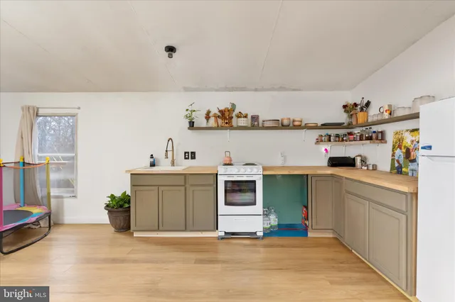 a kitchen with a refrigerator and a sink