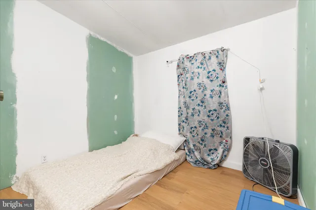 a bedroom with a bed and a curtain