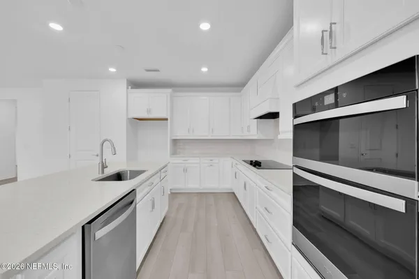 a view of kitchen with center island and stainless steel appliances
