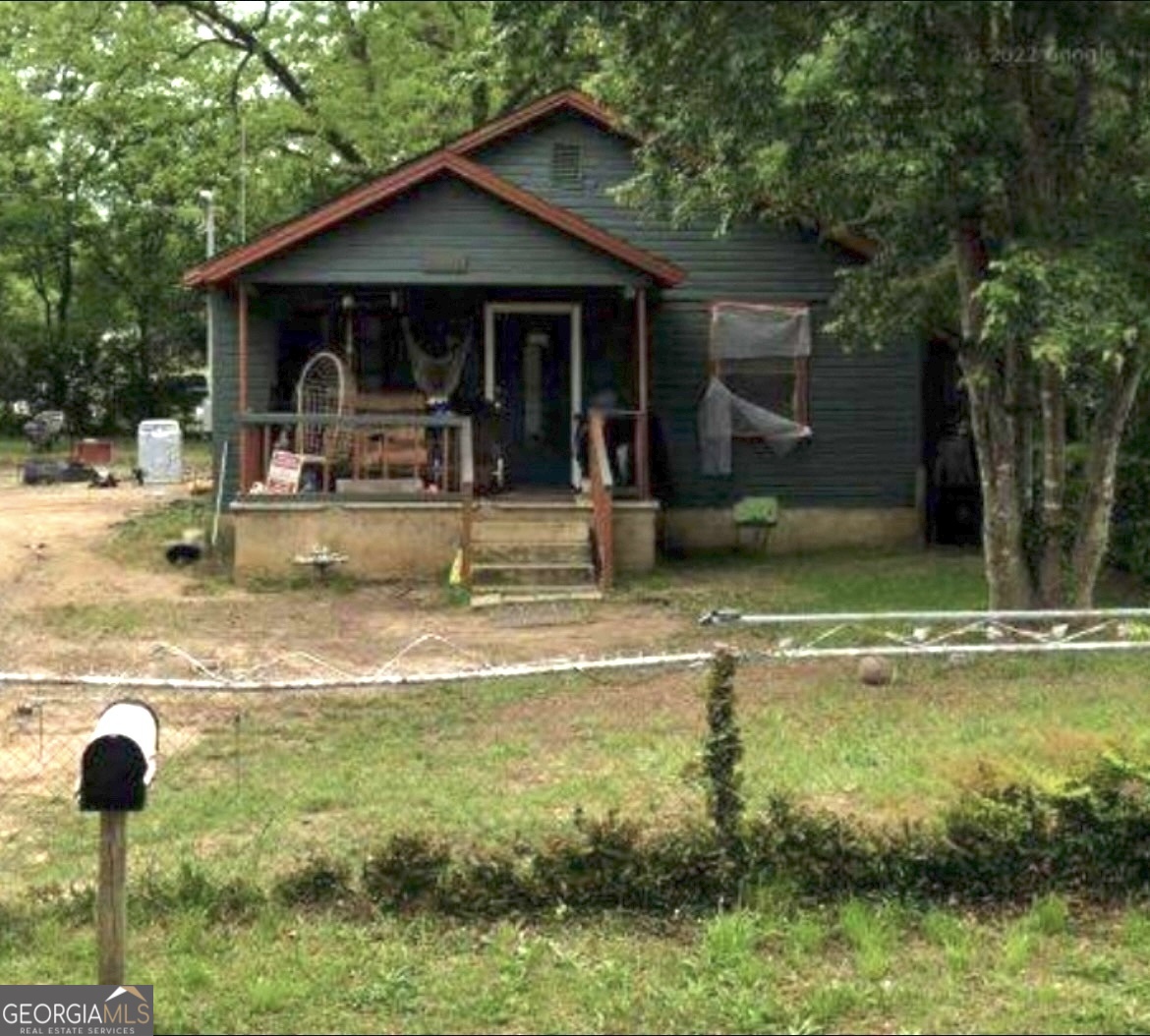 4124 Worsham Avenue Macon, GA 31206 - Photo 1 of 5 a view of a house with swimming pool next to a yard