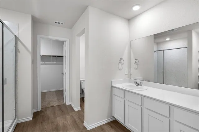a bathroom with a double vanity sink and a mirror