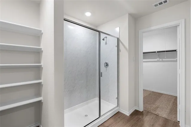 a bathroom with a glass shower door