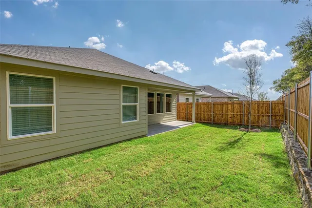 a view of a house with backyard and porch