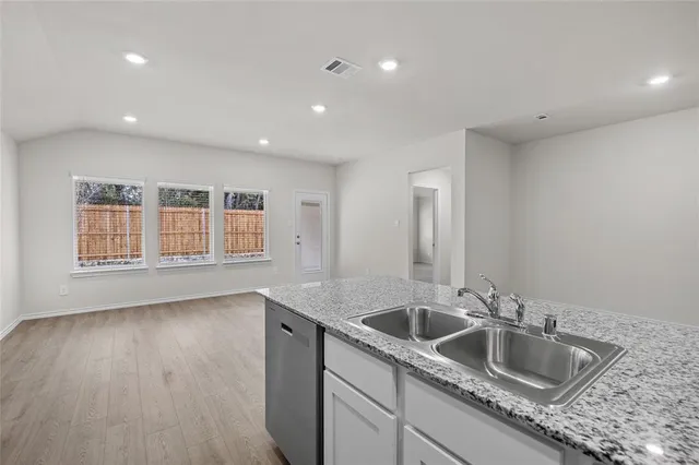 a kitchen with a sink a stove and a microwave