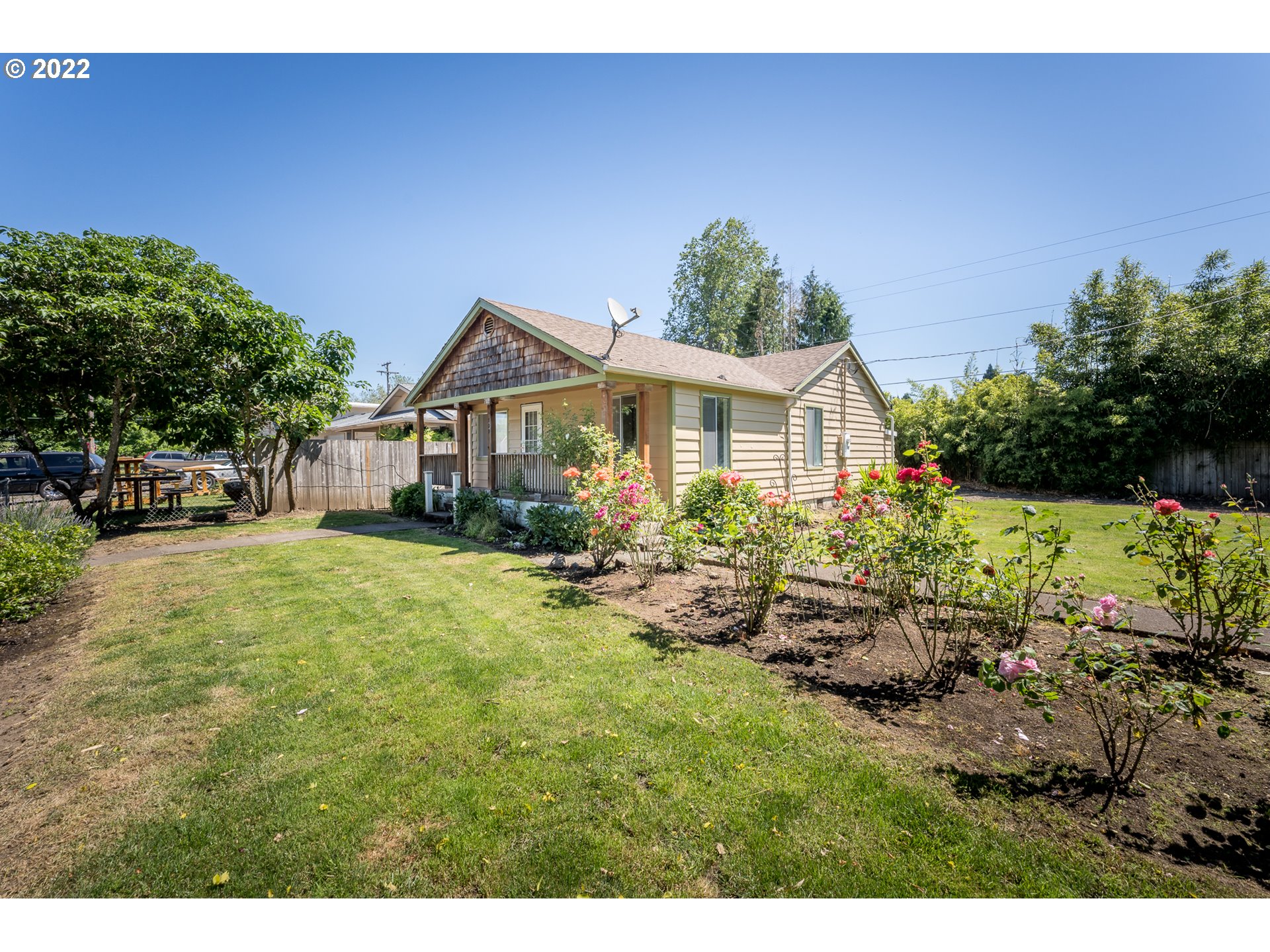 809 60th Street Springfield, OR 97478 - Photo 2 of 17 a front view of a house with a garden and sitting area