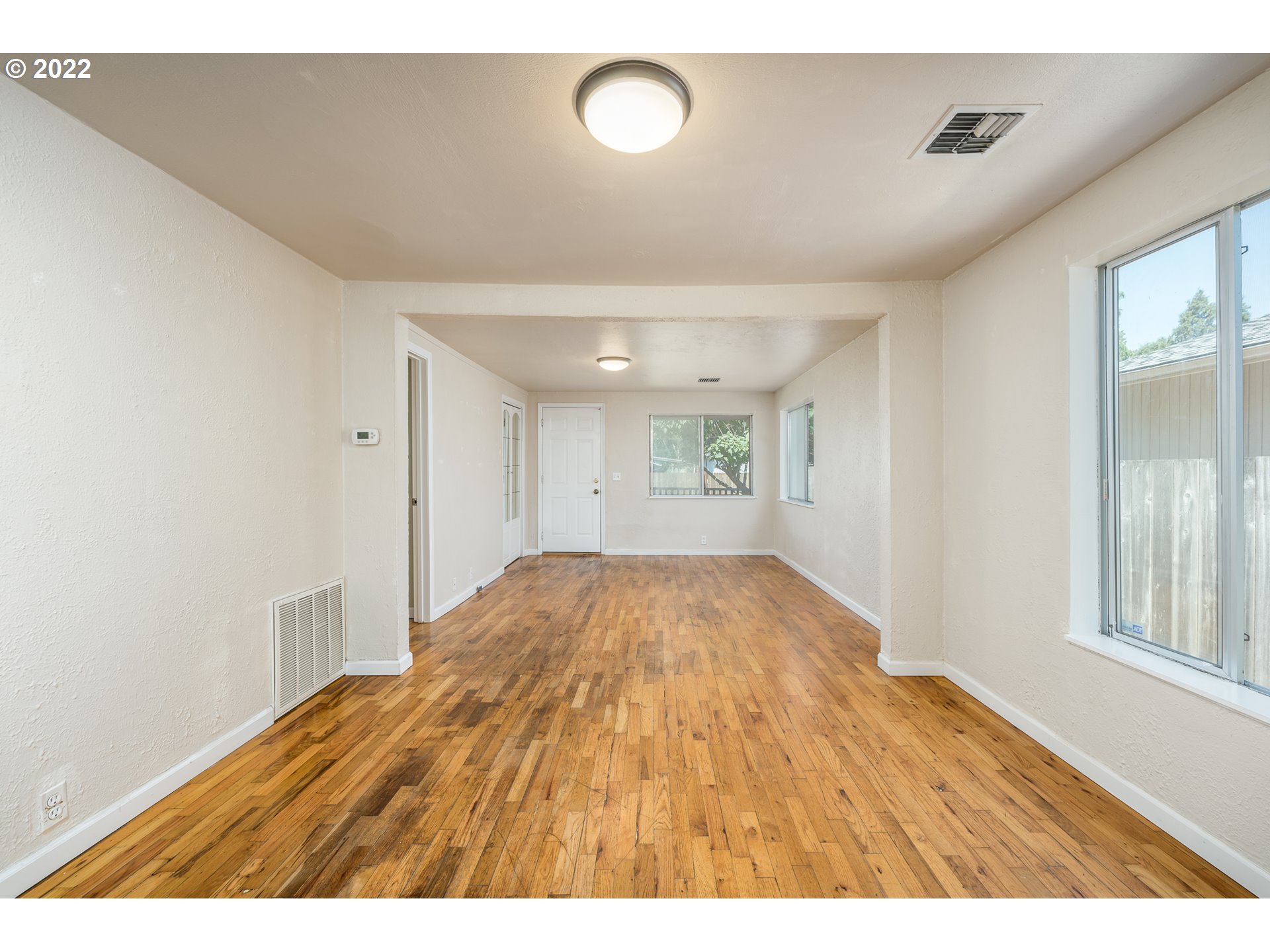 809 60th Street Springfield, OR 97478 - Photo 5 of 17 a view of an empty room and window and wooden floor