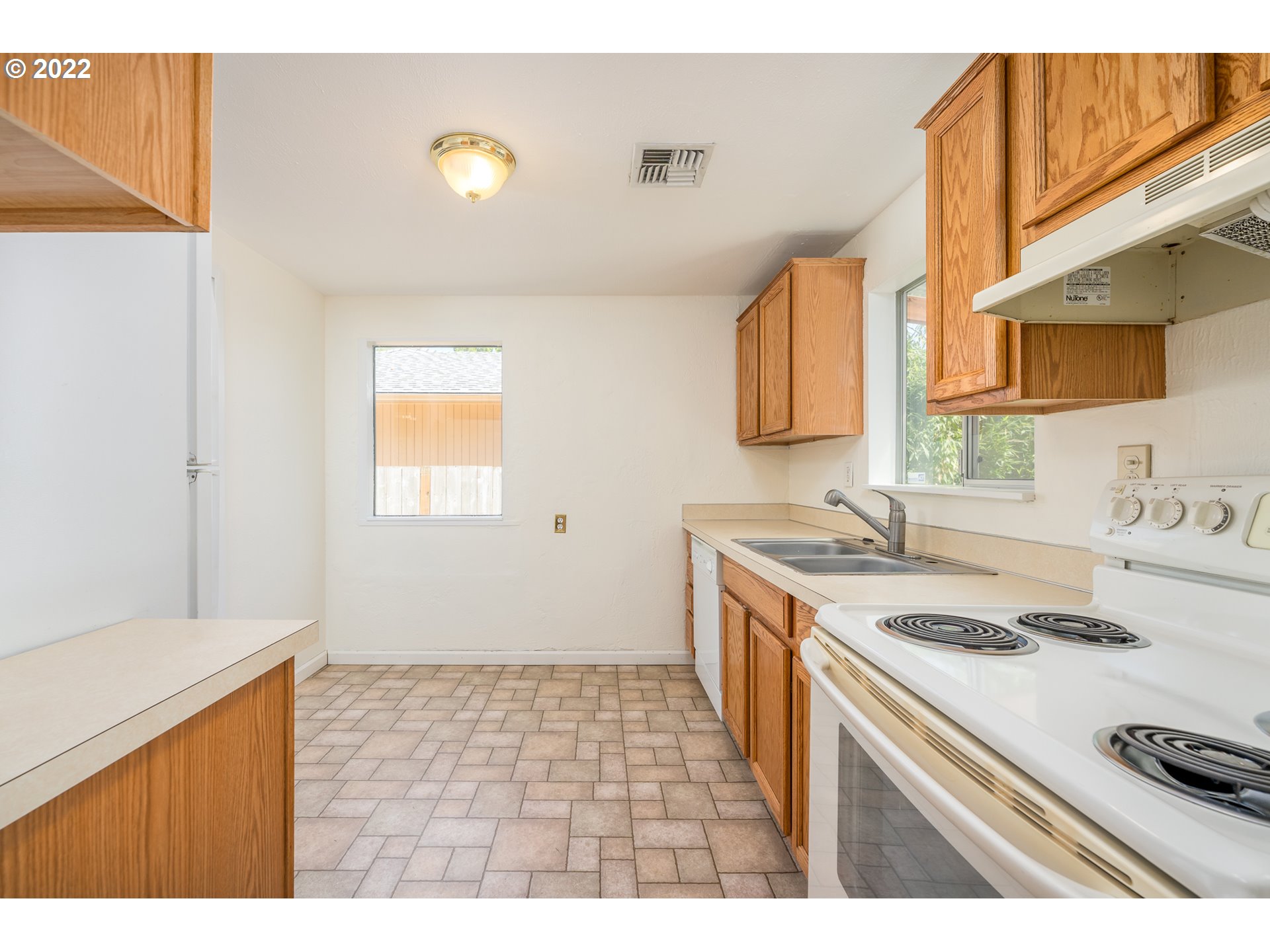 809 60th Street Springfield, OR 97478 - Photo 7 of 17 a kitchen with a sink and a stove top oven