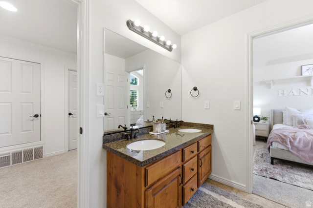 1712 Somerset Ridge Drive Draper, UT 84020 - Photo 42 of 76 Double vanity with a speckled countertop, integrated sinks, and dark bronze-finish fixtures