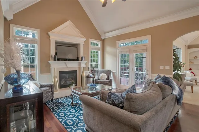 a living room with furniture fireplace and flat screen tv