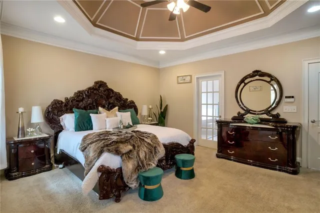 a bedroom with a bed and a chandelier