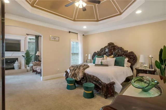 a spacious bedroom with a bed and a chandelier