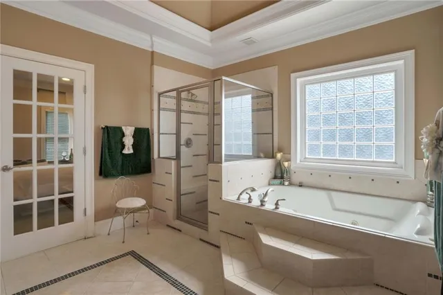 a bathroom with a granite countertop toilet a sink a mirror a bathtub and shower