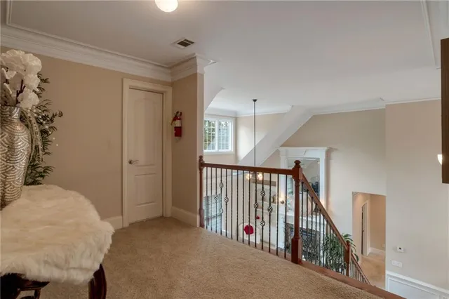 a bed sitting in a bedroom next to a window with a potted plant