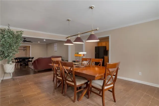 a kitchen with stainless steel appliances granite countertop a refrigerator a sink dishwasher a stove with wooden cabinets and floor