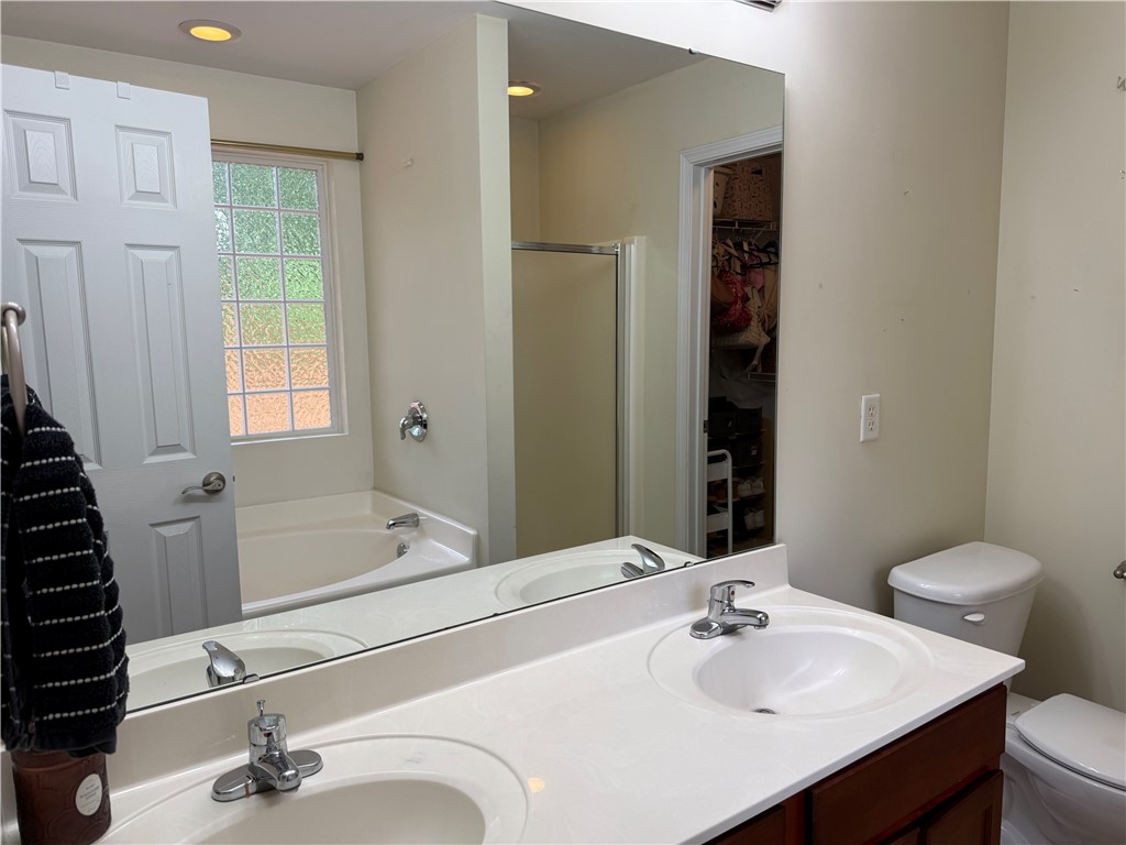 123 Abigail Lane Anderson, SC 29621 - Photo 10 of 22 This bright bathroom features a spacious soaking tub and a dual vanity with ample counter space.