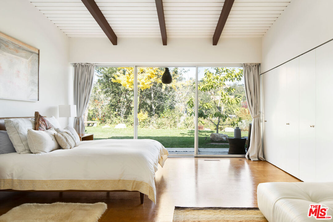 1023 Maybrook Drive Beverly Hills, CA 90210 - Photo 15 of 17 a bedroom with a bed and glass window
