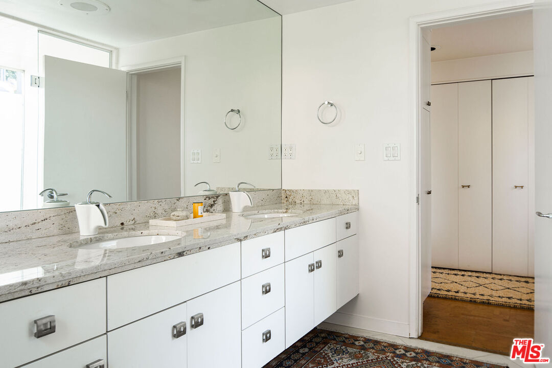 1023 Maybrook Drive Beverly Hills, CA 90210 - Photo 16 of 17 a bathroom with a granite countertop sink and a mirror
