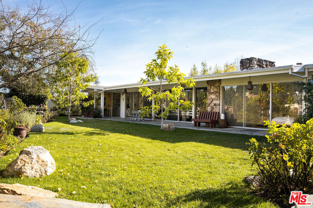 1023 Maybrook Drive Beverly Hills, CA 90210 - Photo 5 of 17 a view of a house with swimming pool and a yard