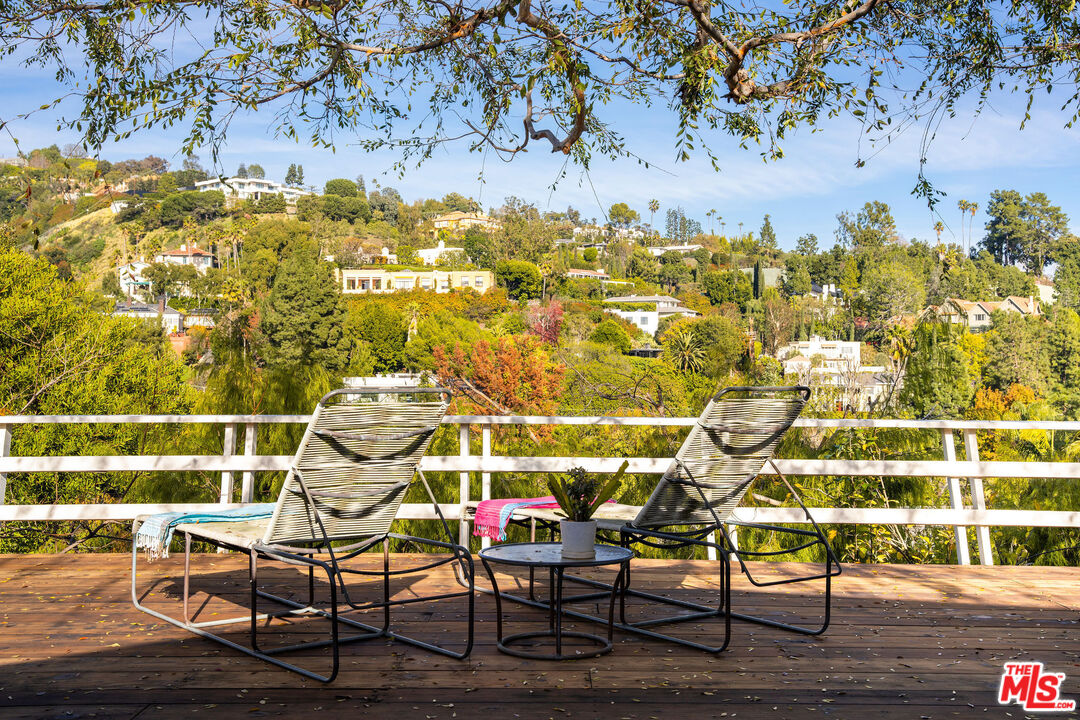 1023 Maybrook Drive Beverly Hills, CA 90210 - Photo 6 of 17 a view of a chairs and table on the wooden floor