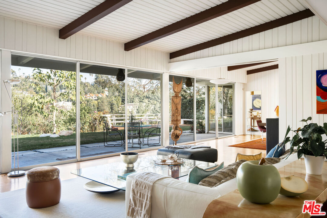 1023 Maybrook Drive Beverly Hills, CA 90210 - Photo 8 of 17 a living room with furniture and a floor to ceiling window