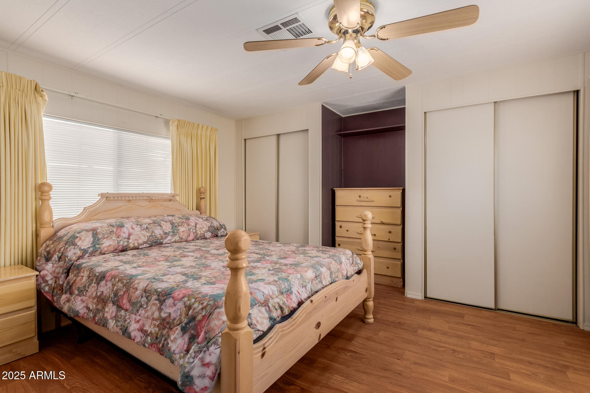 1050 East Broadway Avenue, Unit 84 Apache Junction, AZ 85119 - Photo 15 of 34 a bedroom with a large bed and a chandelier